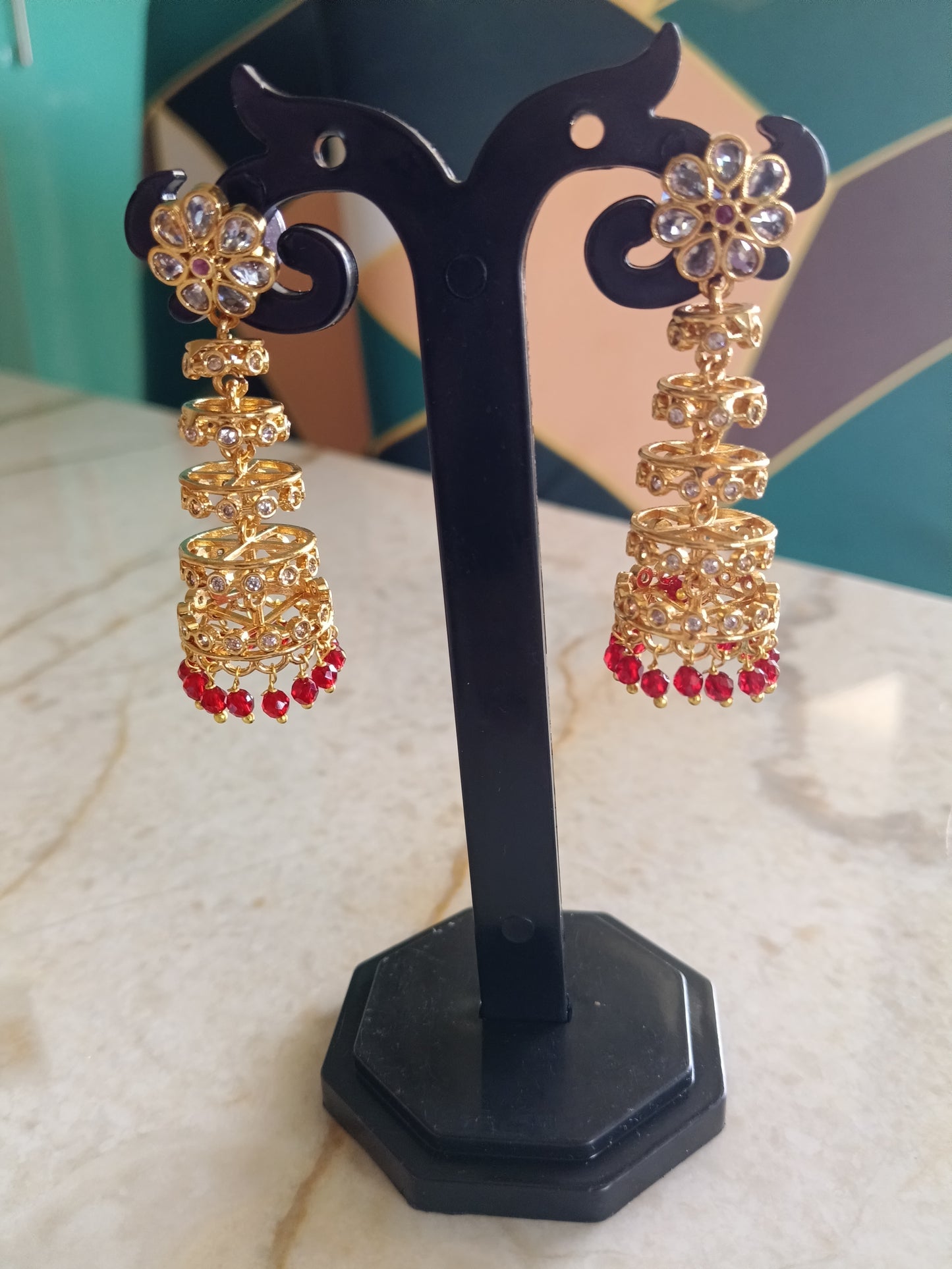 Antique Gold Tiered Jhumka Earrings with Red Beads